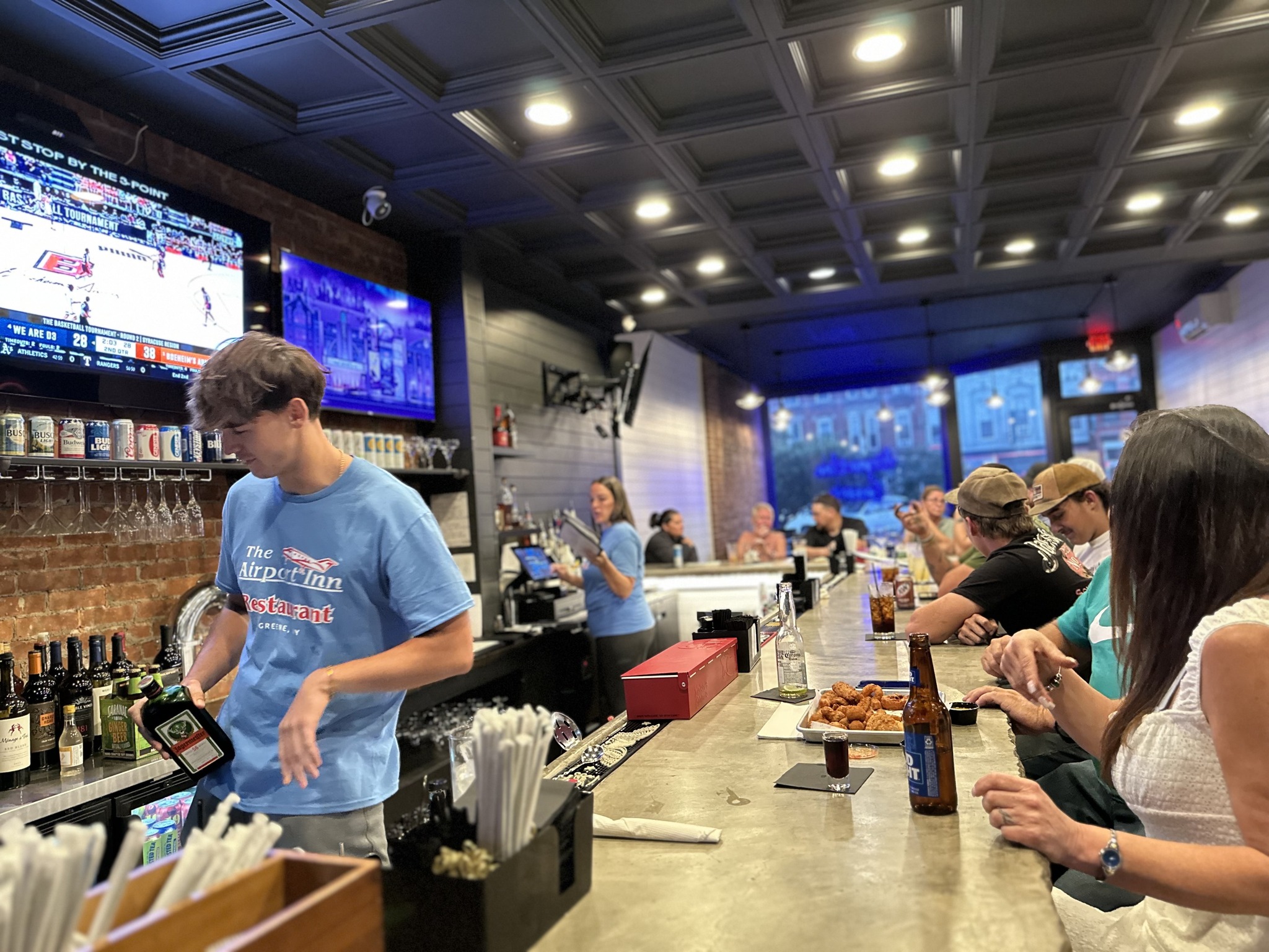 Wide shot of the Greene bar and dining area in the evening with atmospheric lighting