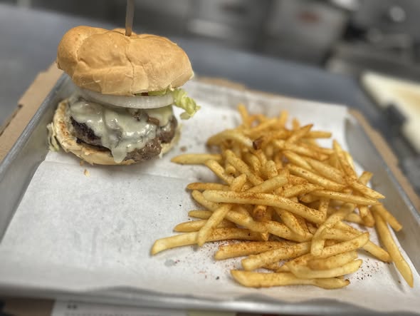 Classic burger with lettuce, swiss cheese, and seasoned fries