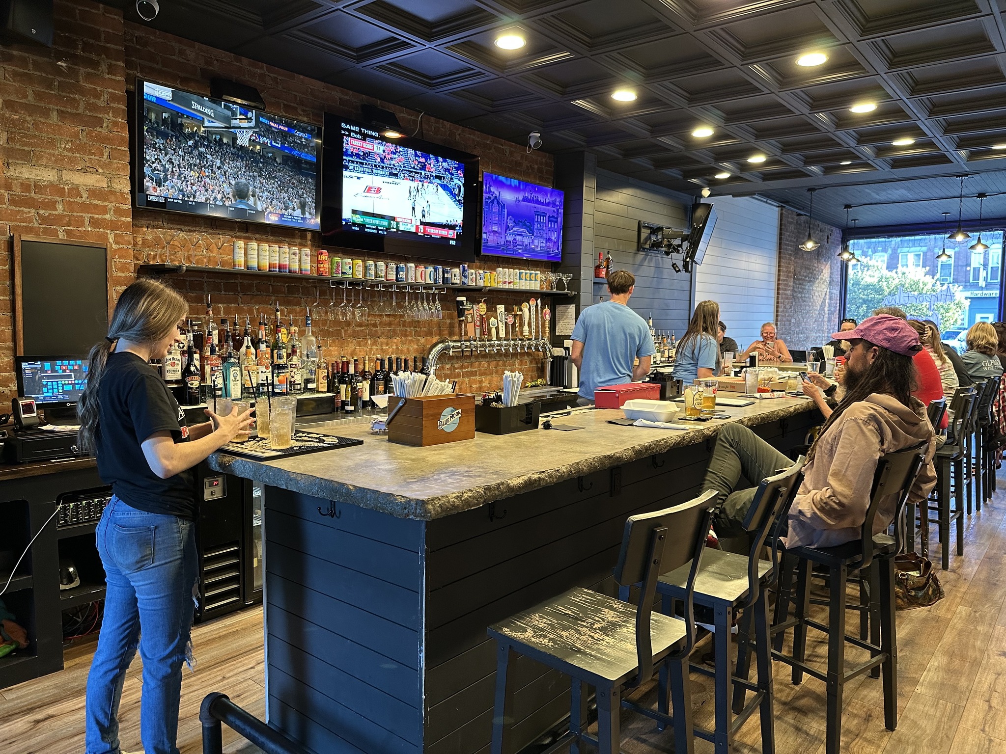 Full spread of wings, appetizers, and drinks on the outdoor patio table